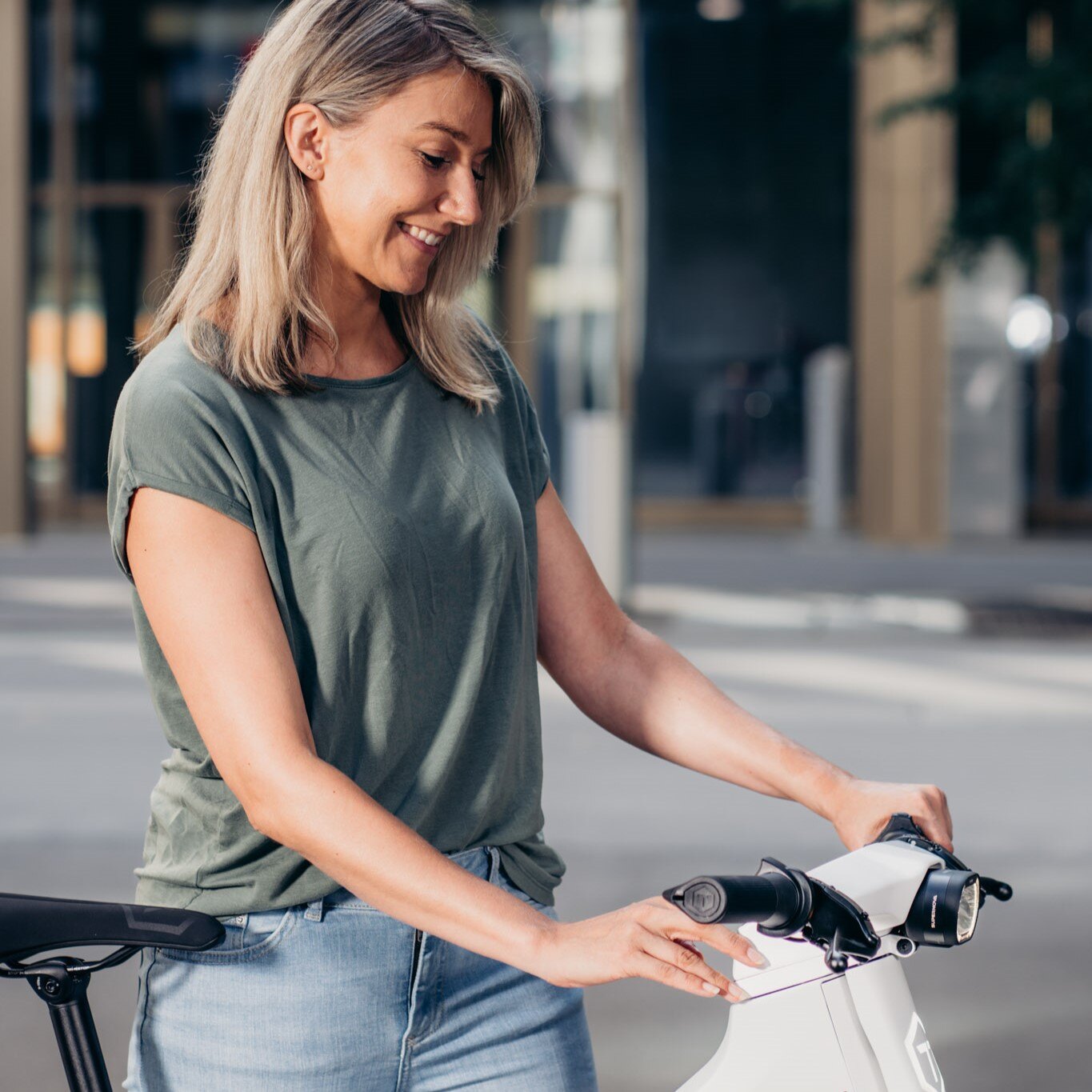 Frau schiebt ein weisses E-Bike Twinner